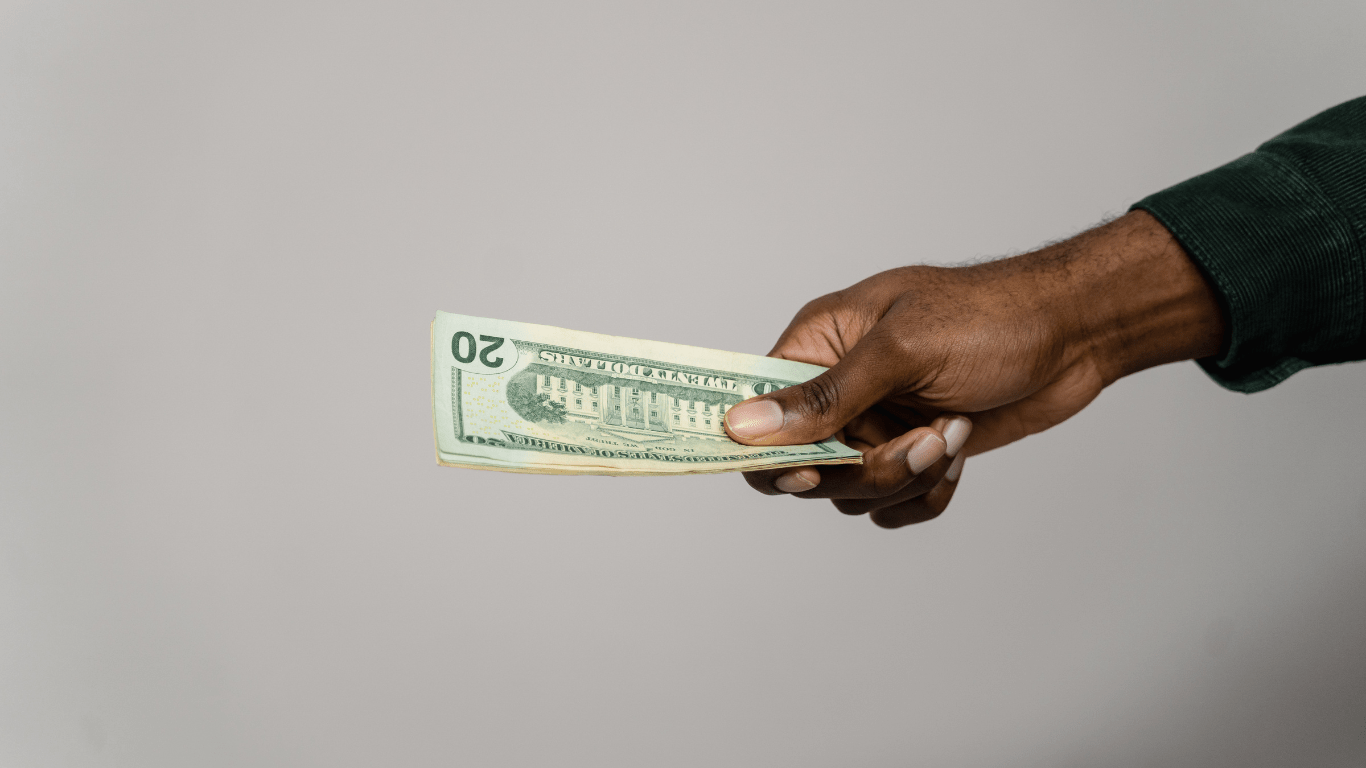 a person holding a us dollar