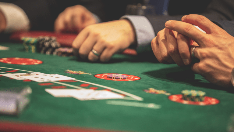 a group of people playing blackjack at a casino table