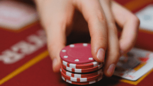 a person holding casino chips