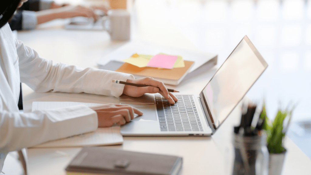 a person typing on a laptop computer